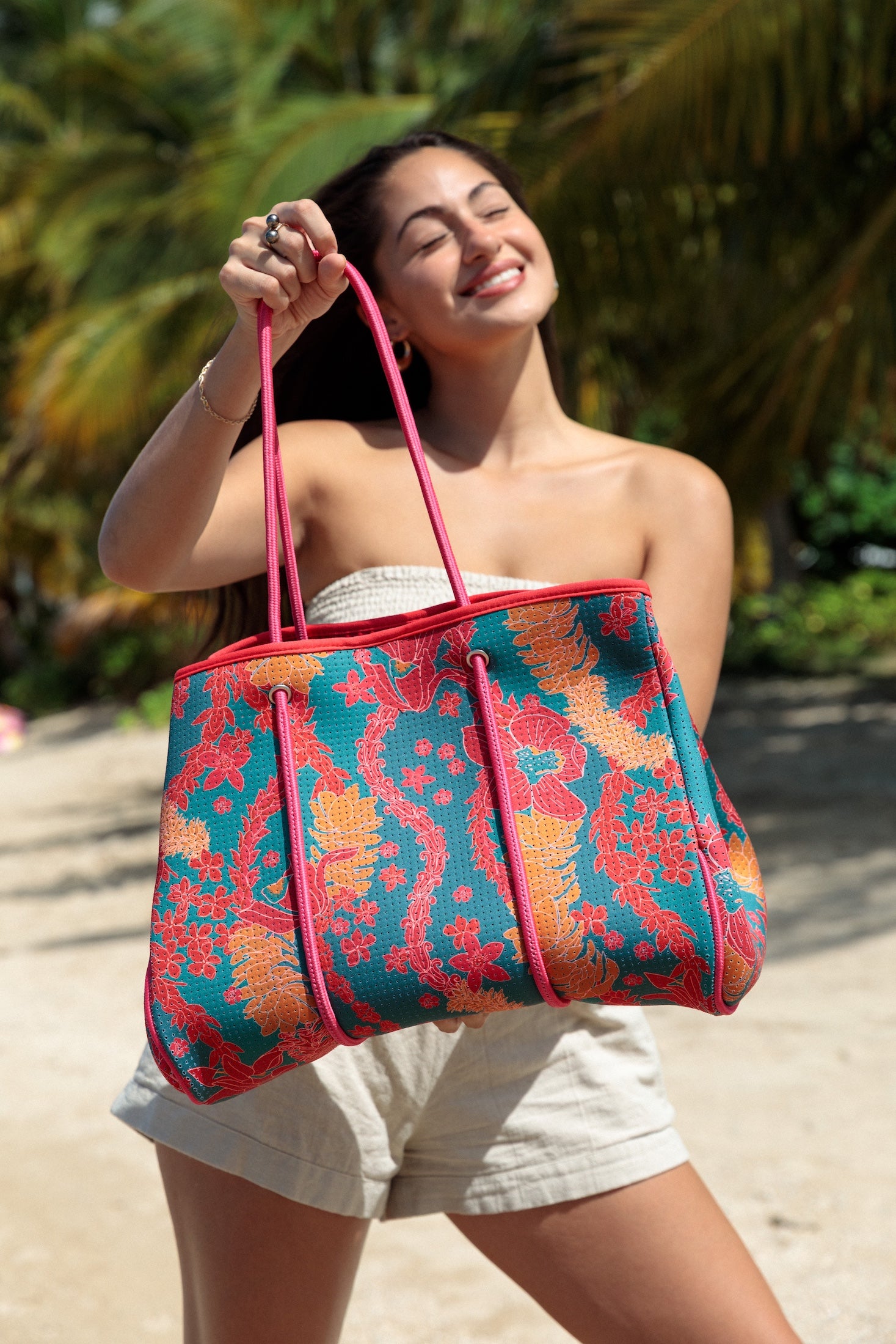 large rich blue neoprene tote bag with red and orange lei pattern