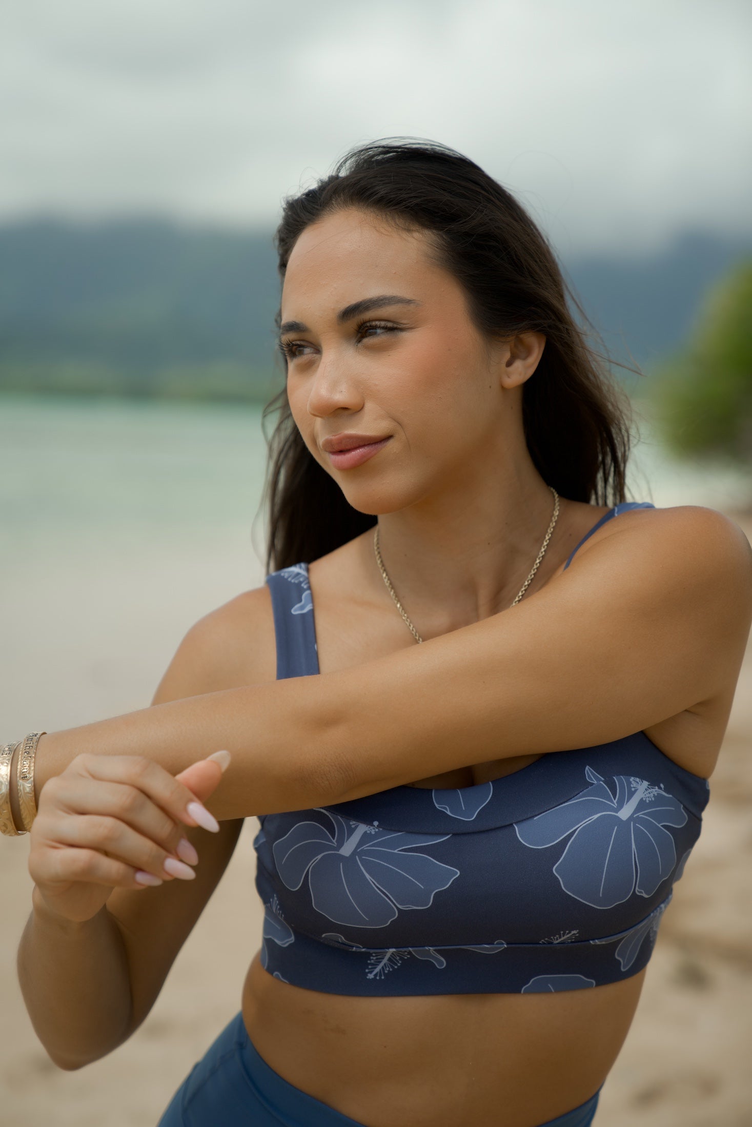 woman wearing a sports bra with blue hibiscus pattern