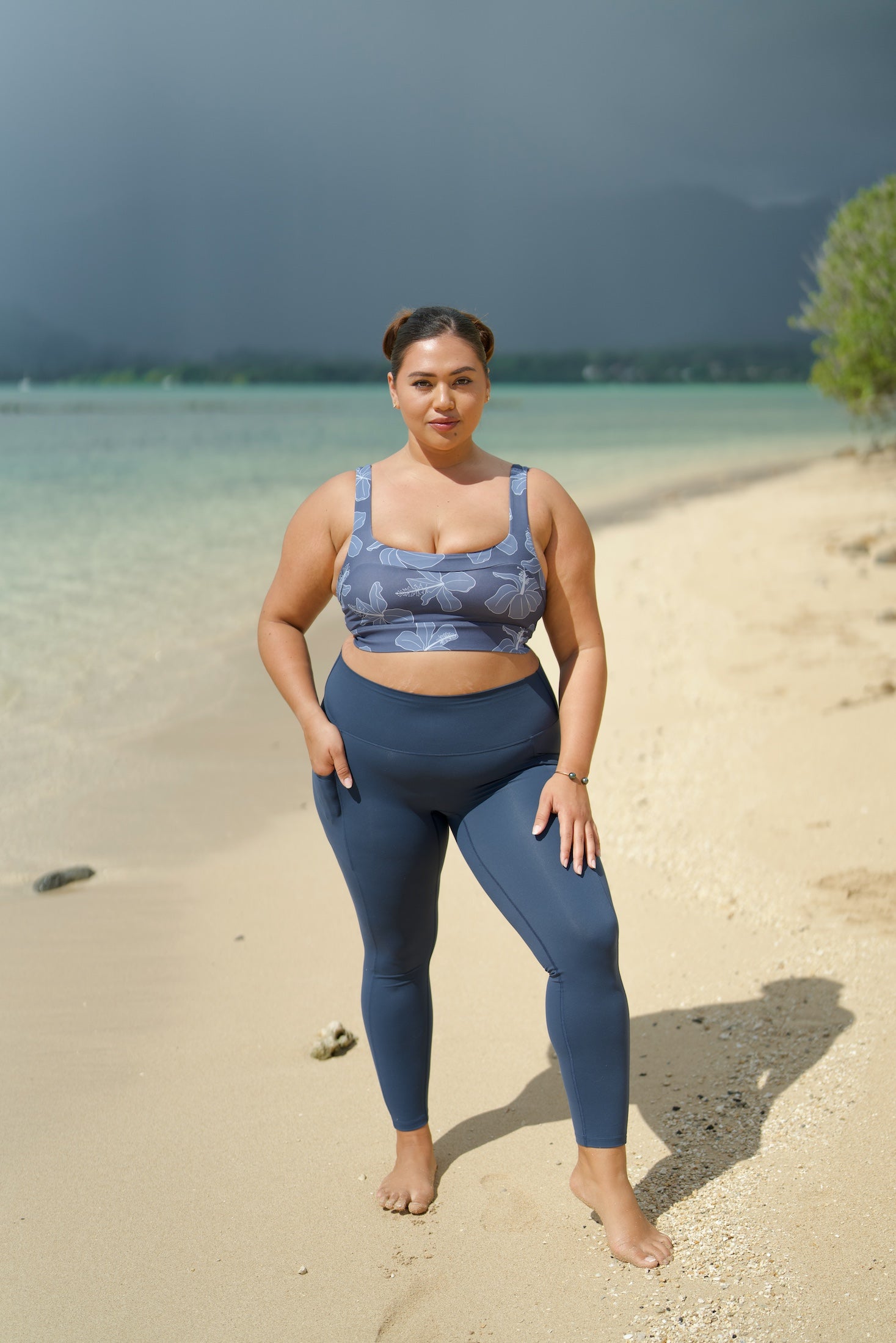 woman wearing a sports bra with blue hibiscus pattern