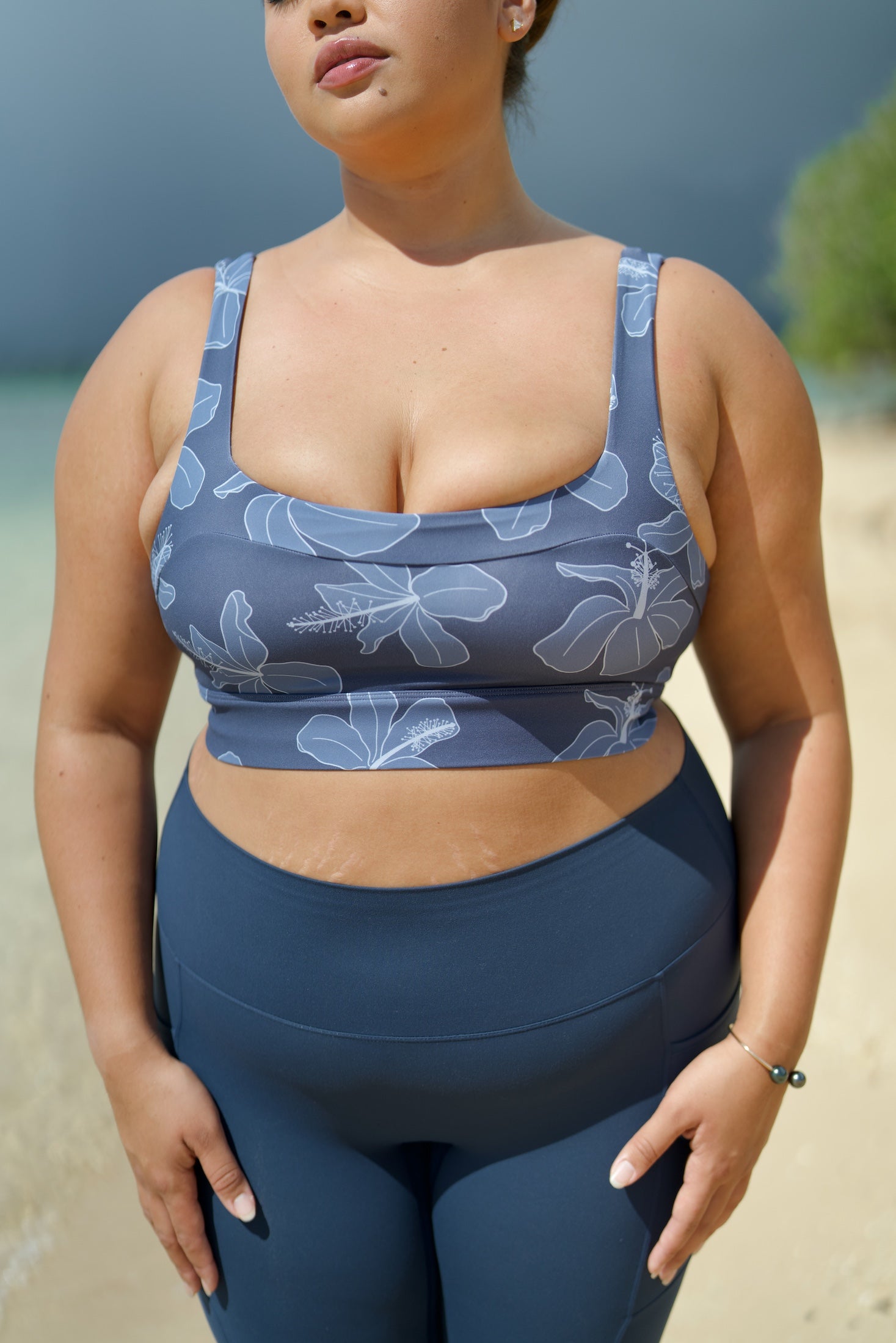 woman wearing a sports bra with blue hibiscus pattern