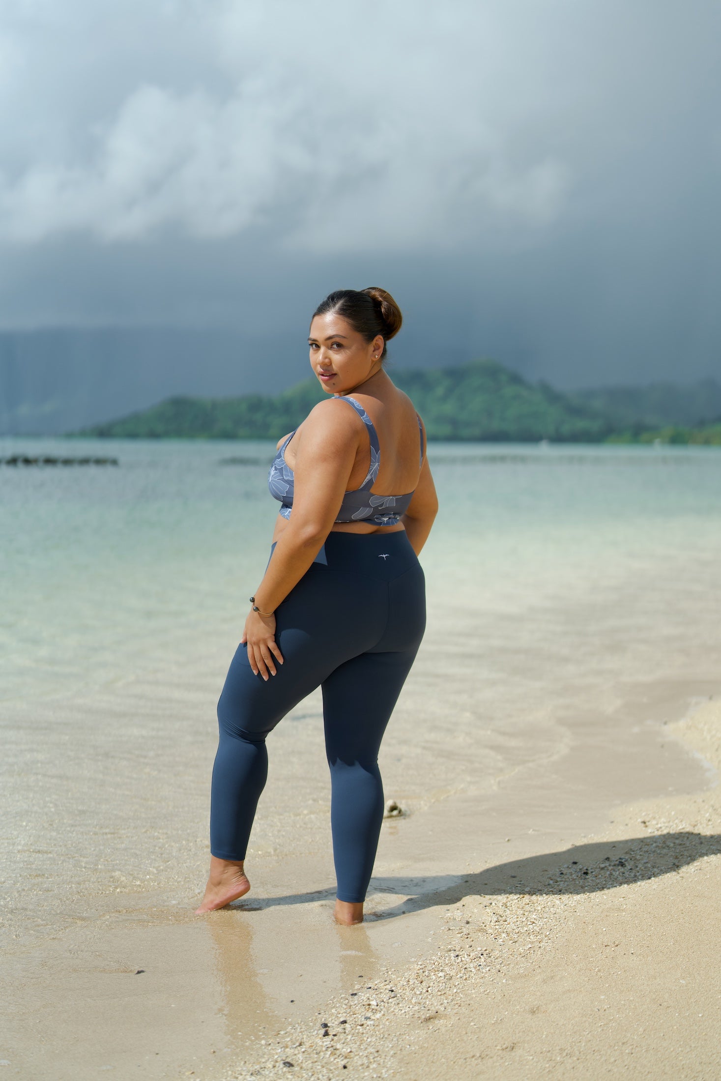 woman wearing a sports bra with blue hibiscus pattern