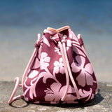brown neoprene drawstring crossbody purse with pink hibiscus pattern