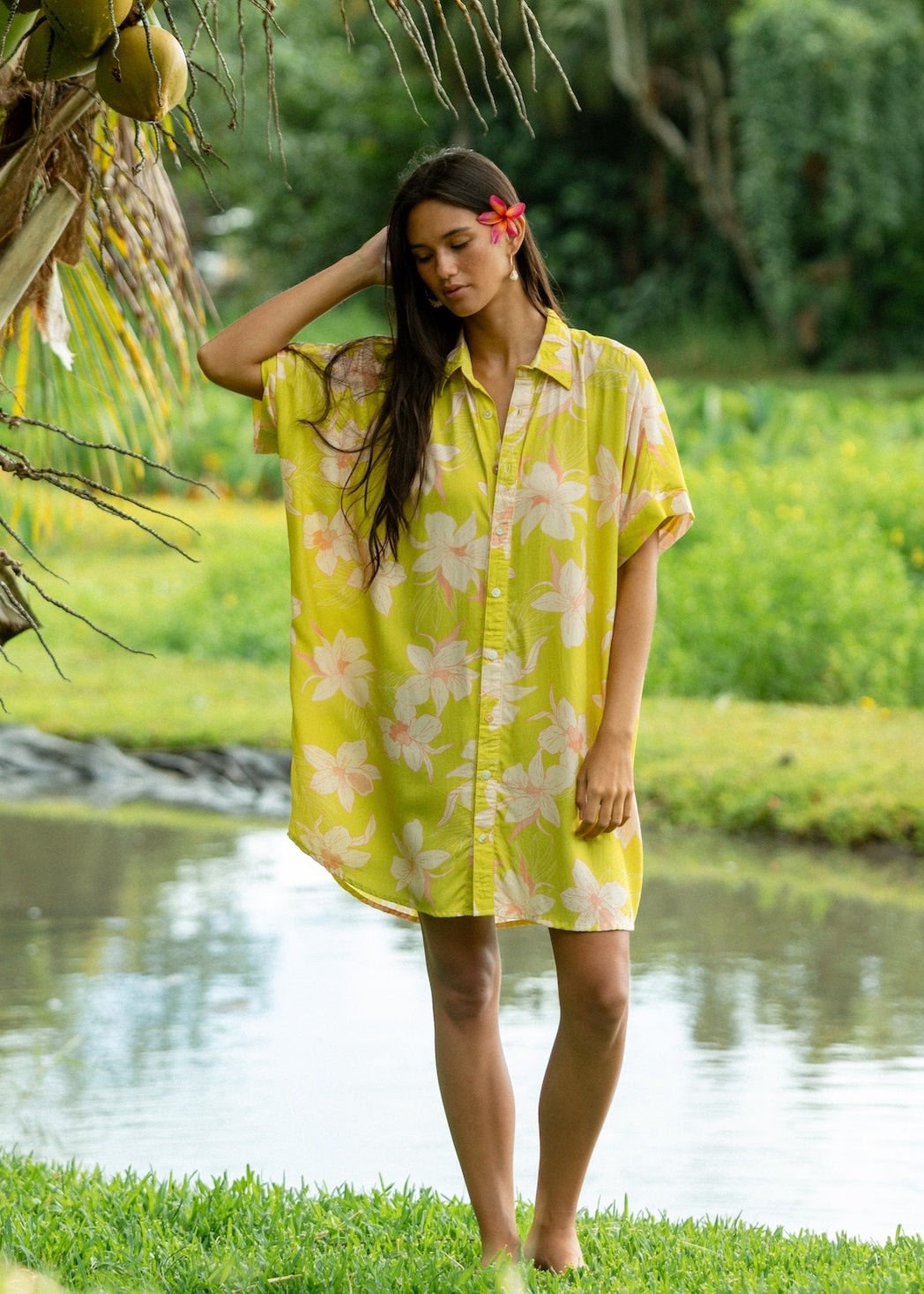 woman wearing a bright green button up dress with orchid print