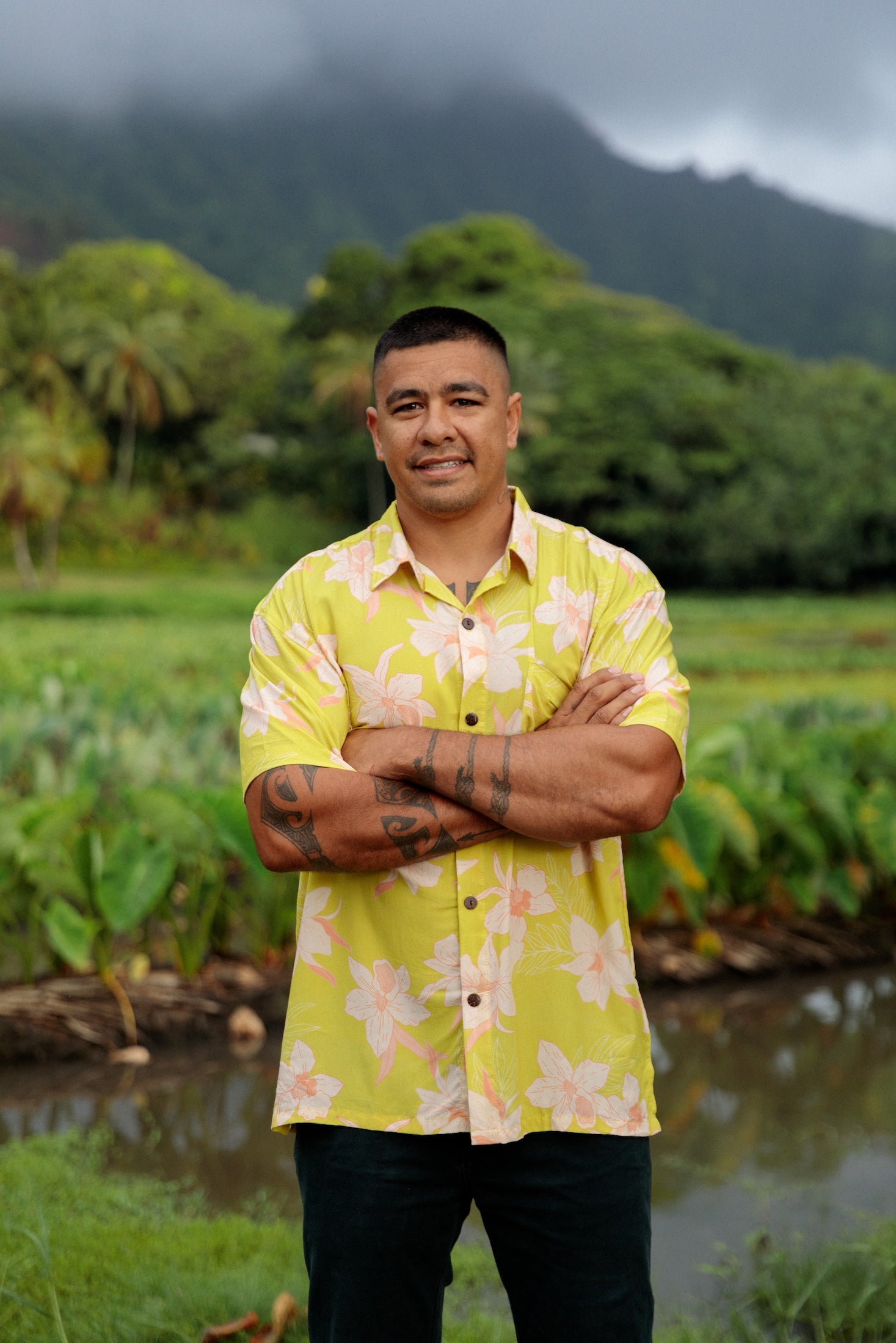 man wearing bright yellow green aloha button up shirt with orchid print