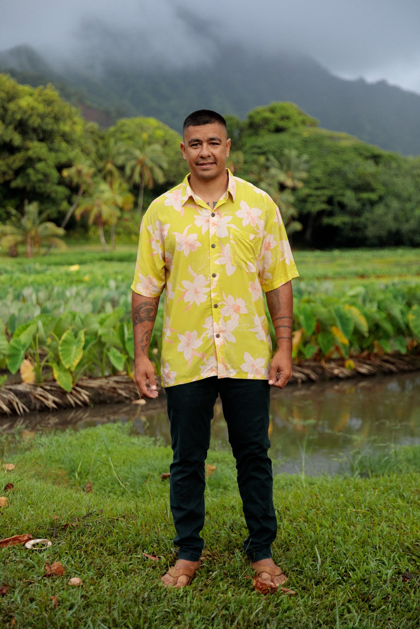 man wearing bright yellow green aloha button up shirt with orchid print