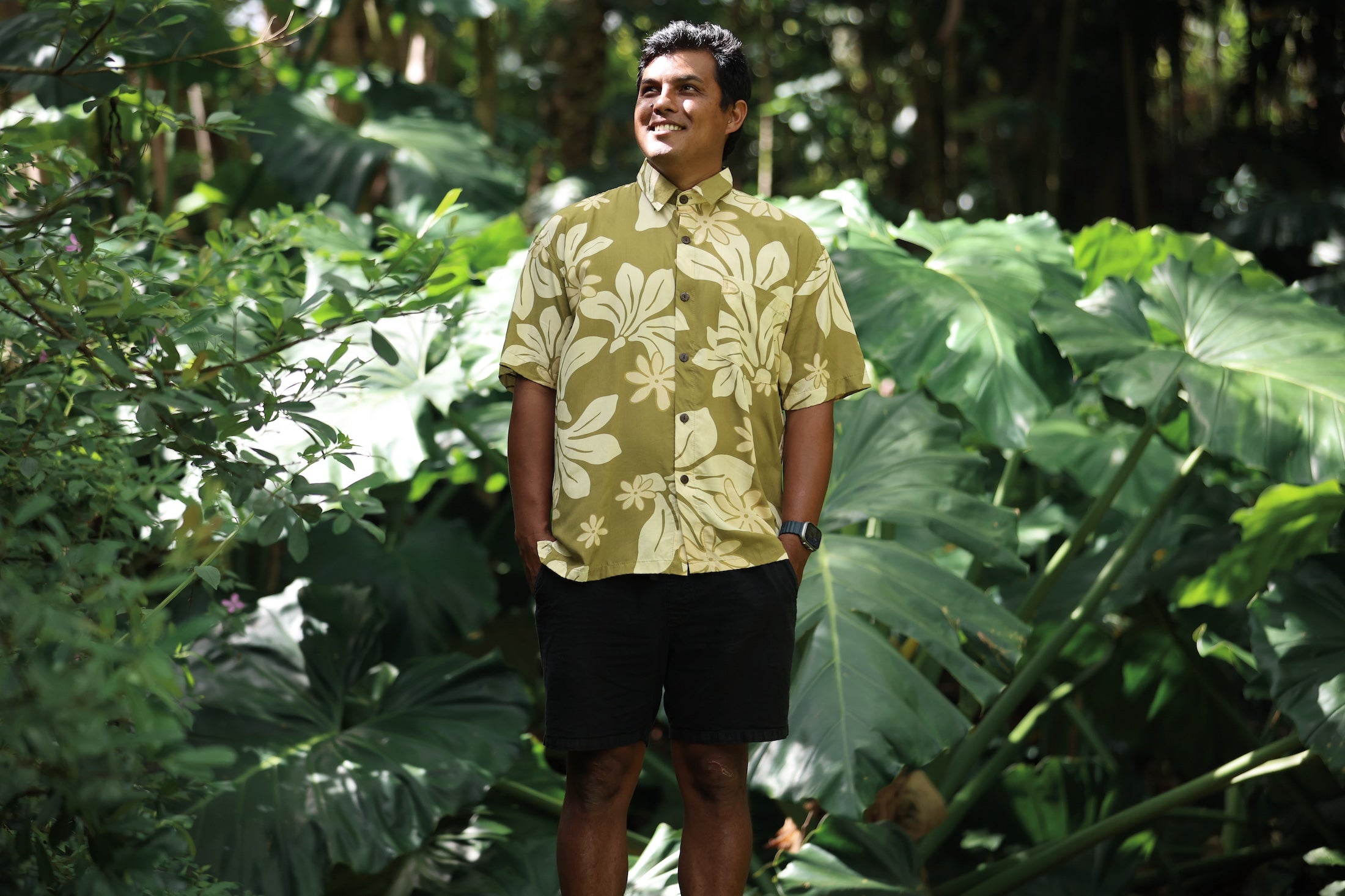 man wearing aloha button up shirt in green print with naupaka pattern