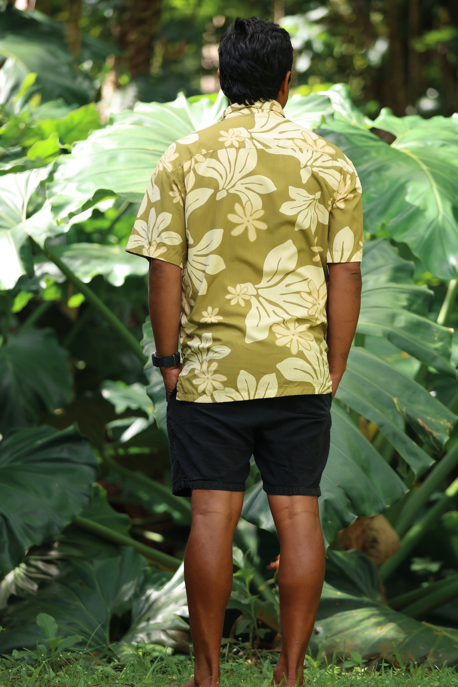 man wearing aloha button up shirt in green print with naupaka pattern