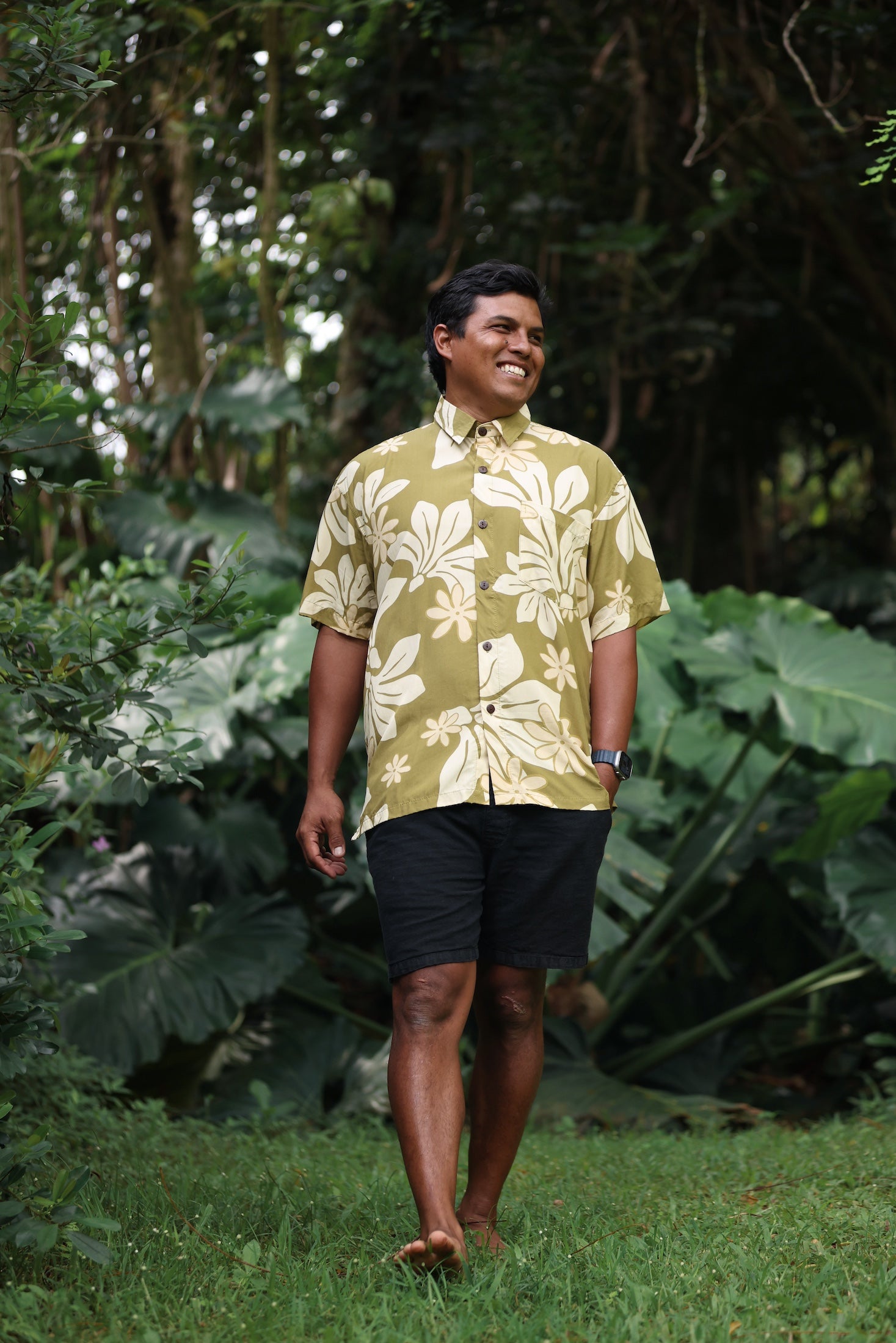 man wearing aloha button up shirt in green print with naupaka pattern