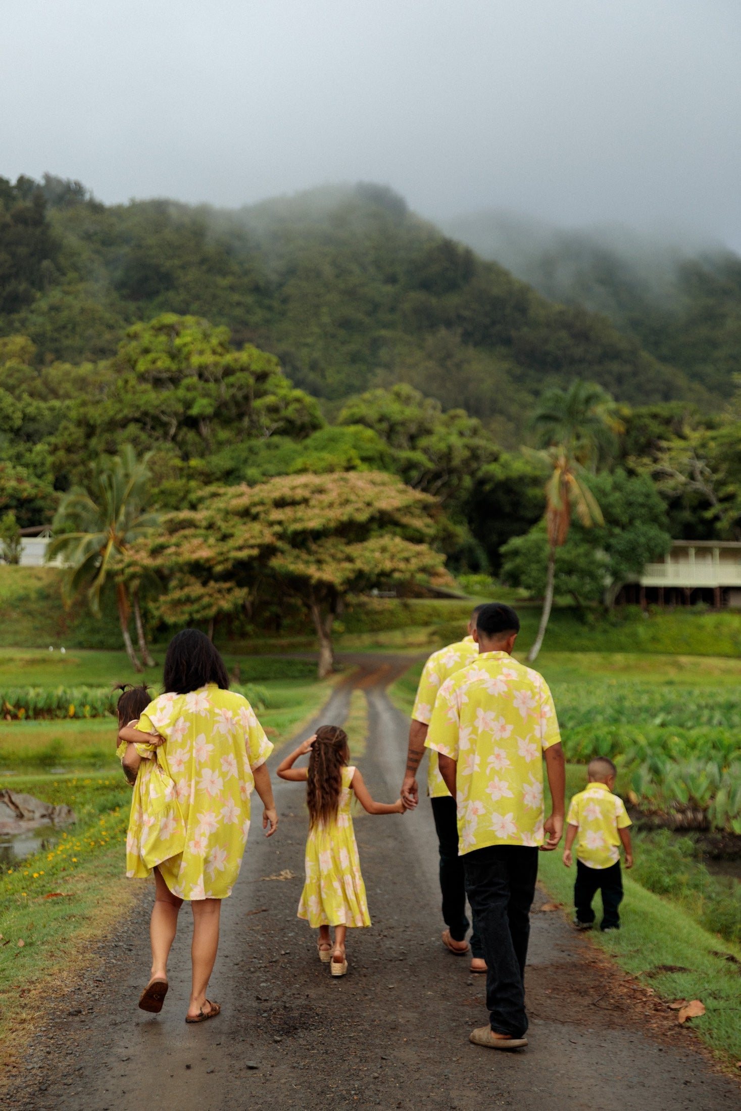 family wearing matching bright green aloha wear with orchid print
