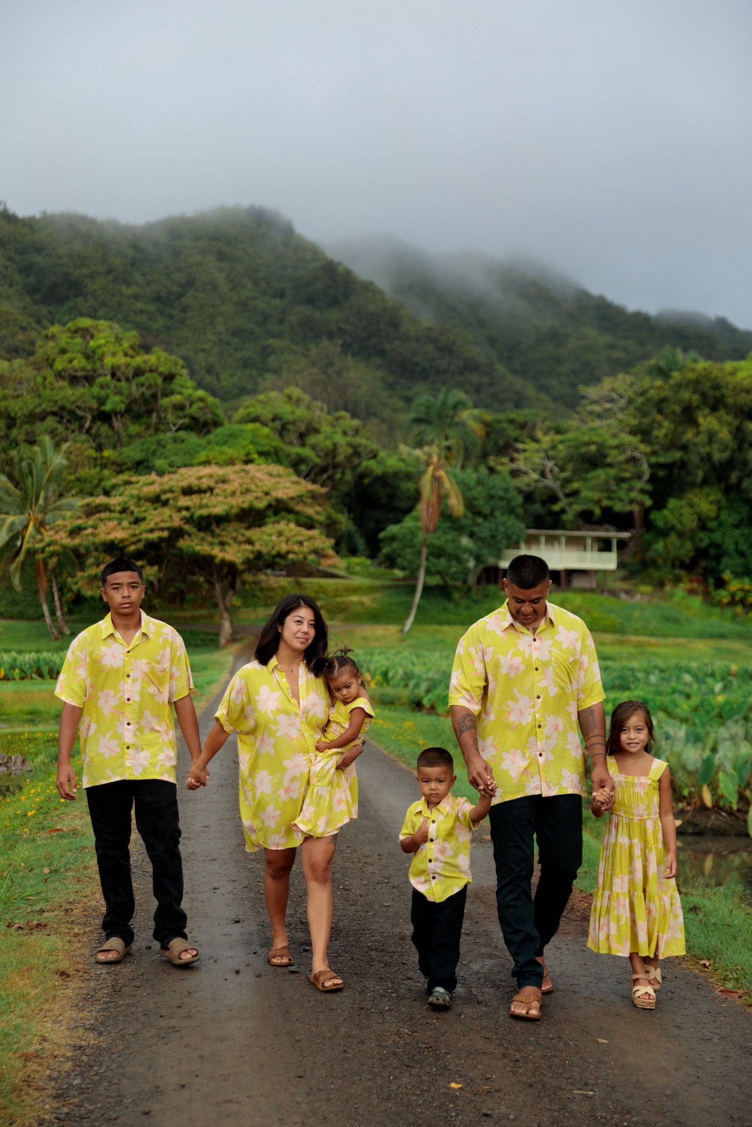 family wearing matching bright green aloha wear with orchid print
