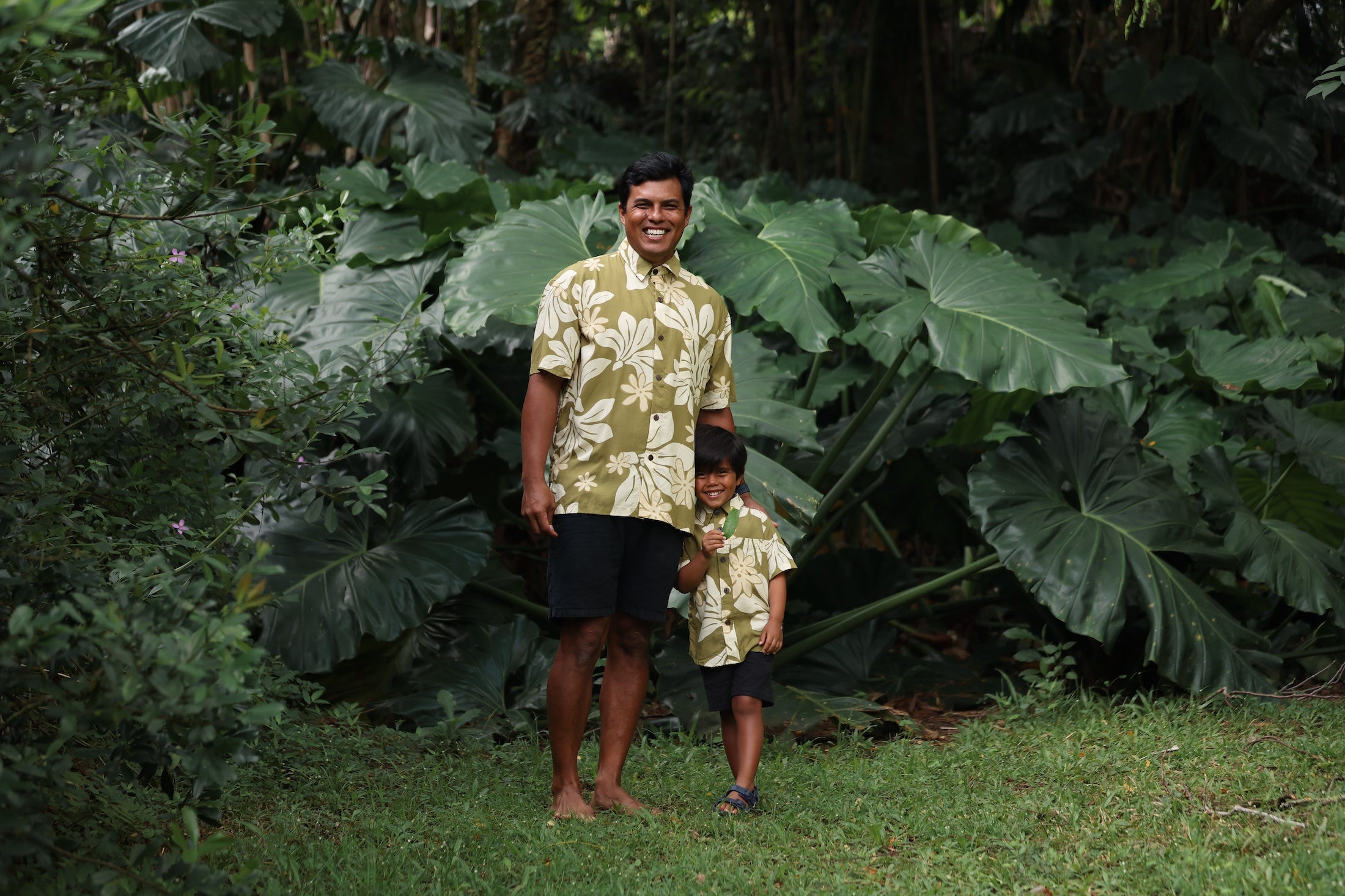 family wearing matching aloha wear in green print with naupaka pattern