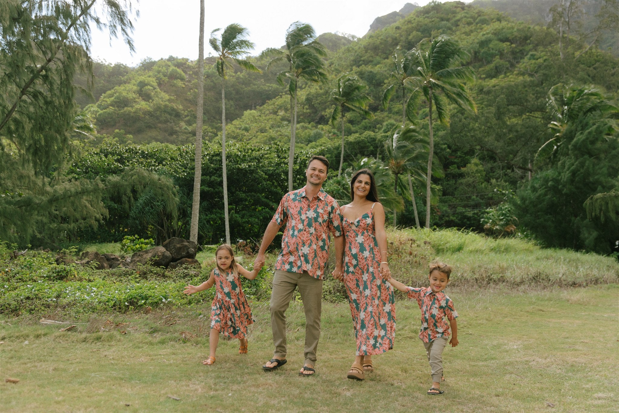 man wearing an aloha button up shirt with red ginger and tiare print