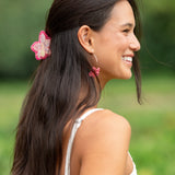 woman wearing a small pink and peach orchid hairclip in hair