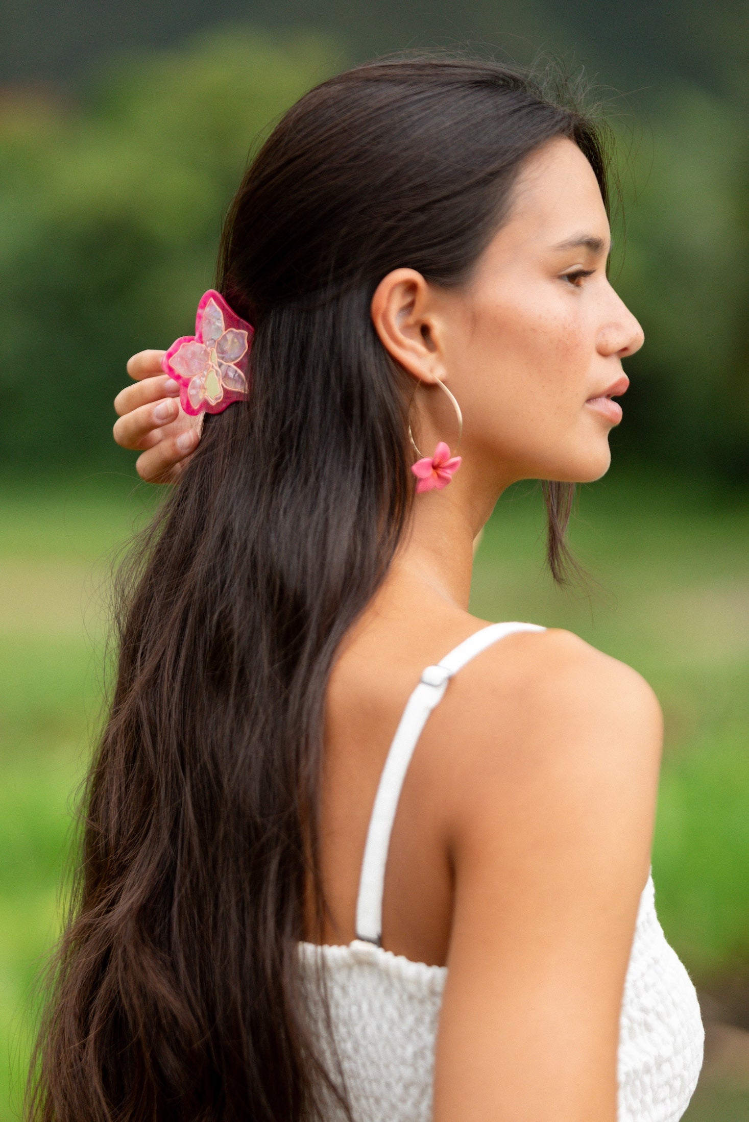 woman wearing a small pink and peach orchid hairclip in hair