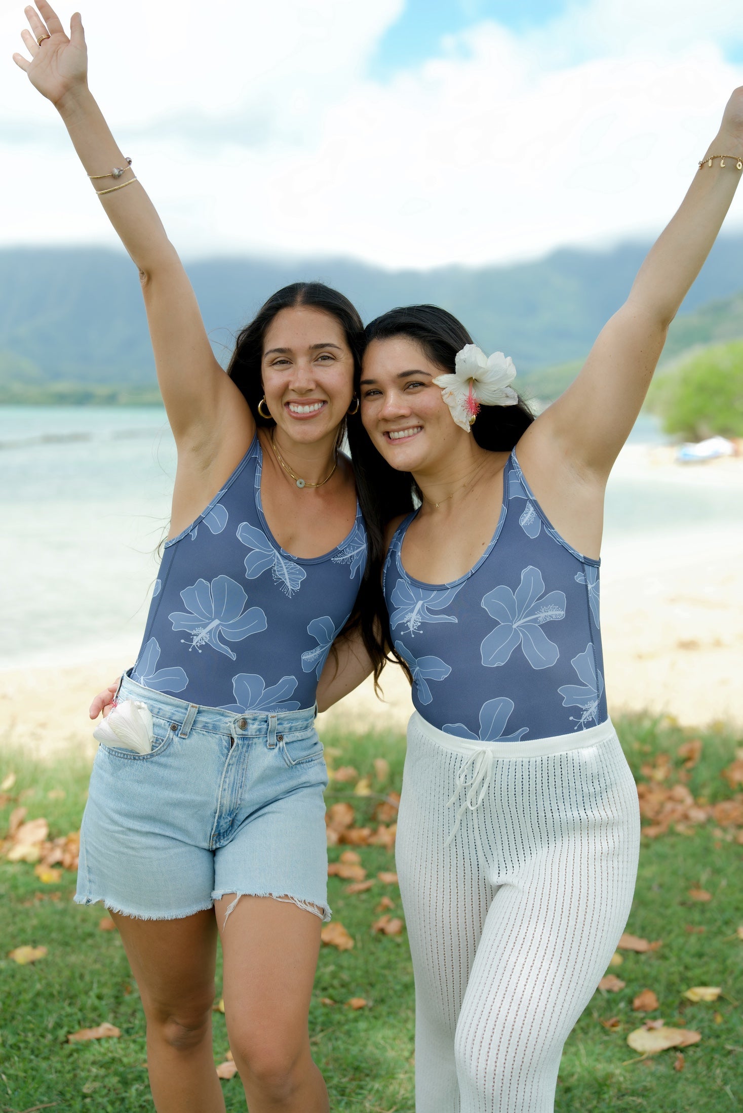 woman wearing a bodysuit with blue hibiscus pattern