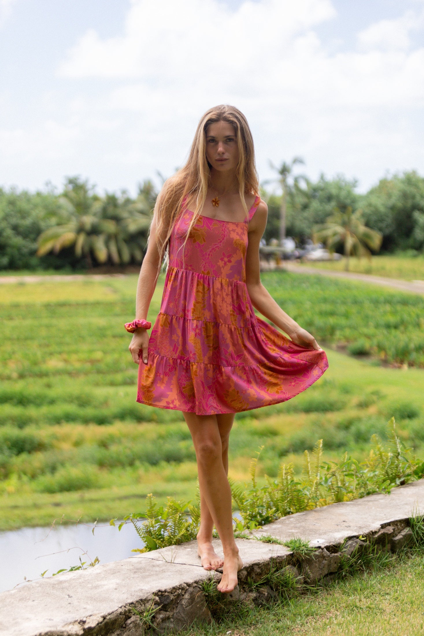 woman wearing a pink mini dress with lei print