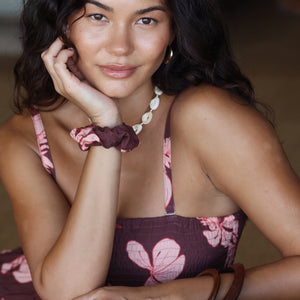 woman wearing mauve scrunchie with lei awapuhi print in hair
