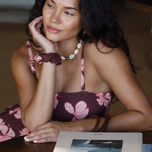 woman wearing mauve scrunchie with lei awapuhi print in hair