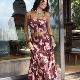 woman wearing brown maxi skirt with light pink lei awapuhi print