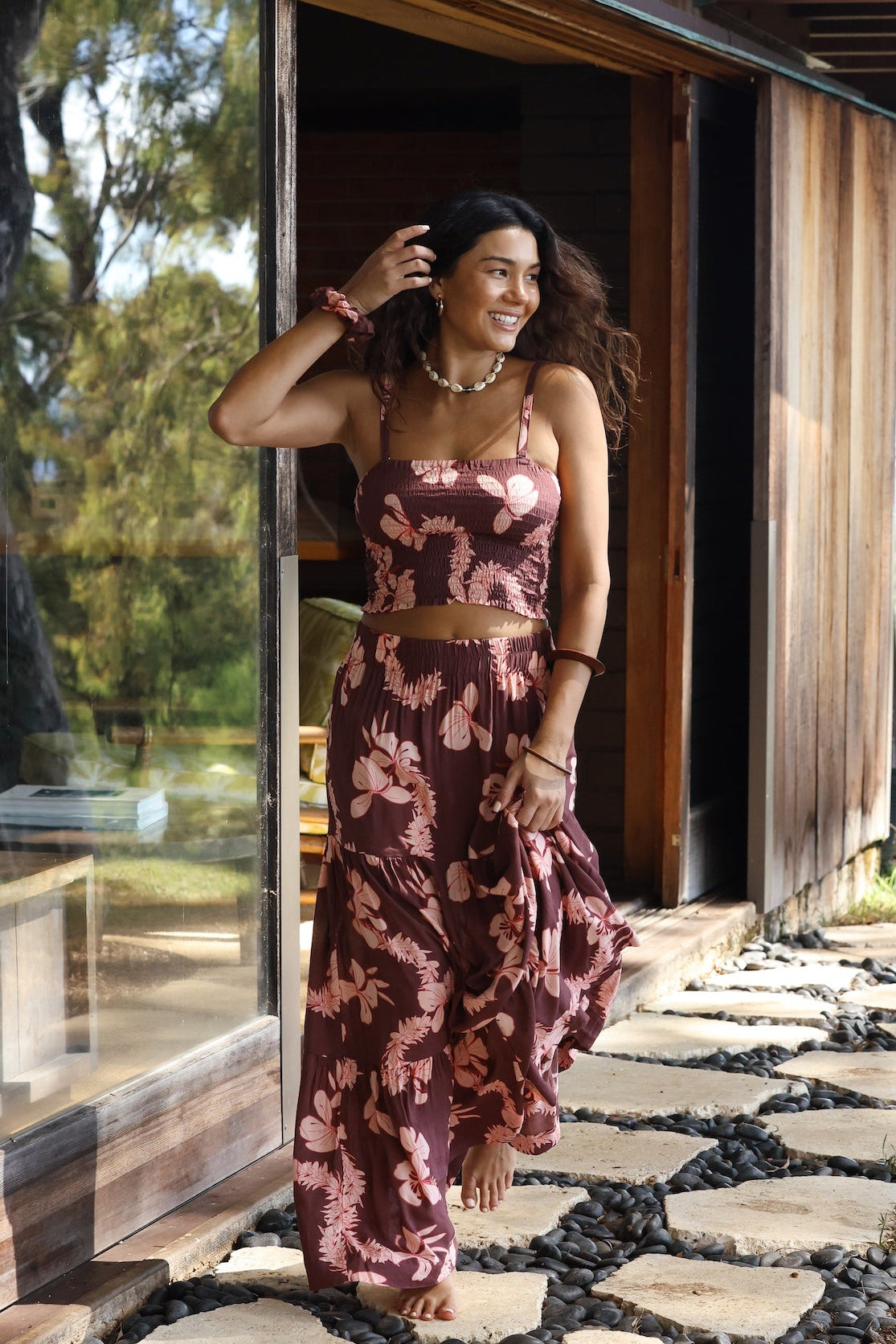 woman wearing brown bandeau with light pink lei awapuhi print