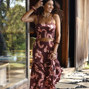 woman wearing brown bandeau with light pink lei awapuhi print