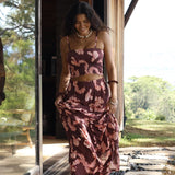 woman wearing brown maxi skirt with light pink lei awapuhi print