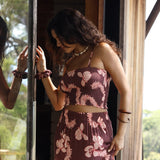 woman wearing brown bandeau with light pink lei awapuhi print