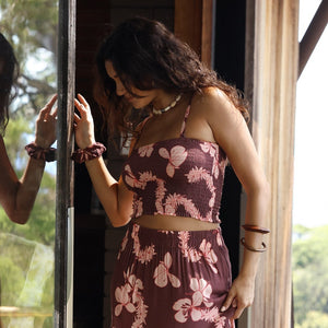 woman wearing brown bandeau with light pink lei awapuhi print