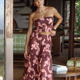 woman wearing brown maxi skirt with light pink lei awapuhi print