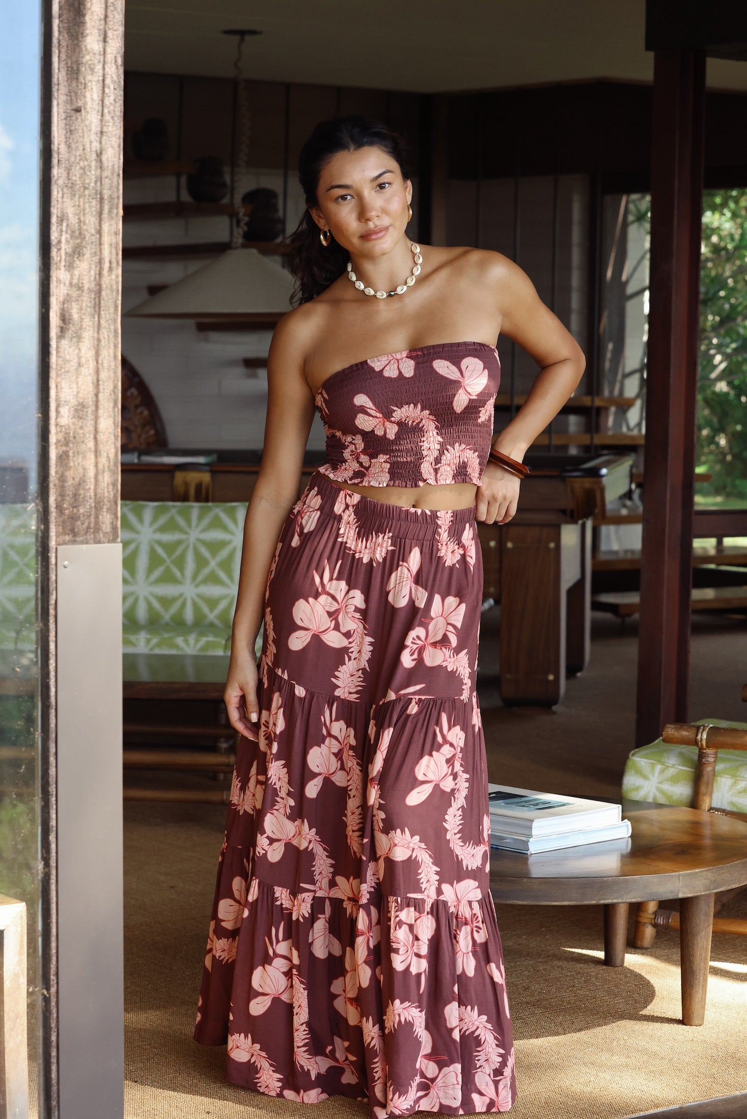 woman wearing brown maxi skirt with light pink lei awapuhi print