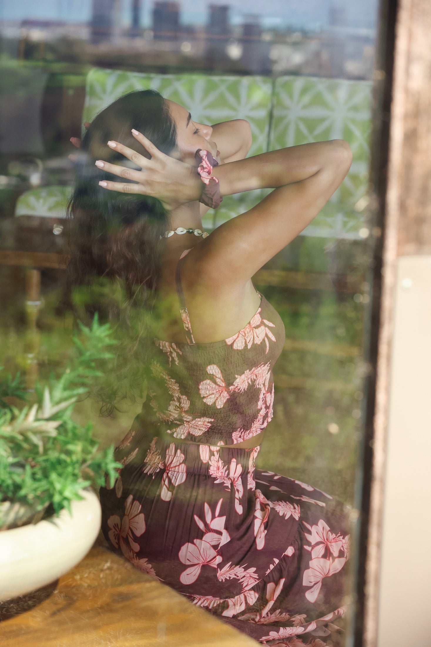 woman wearing mauve scrunchie with lei awapuhi print in hair