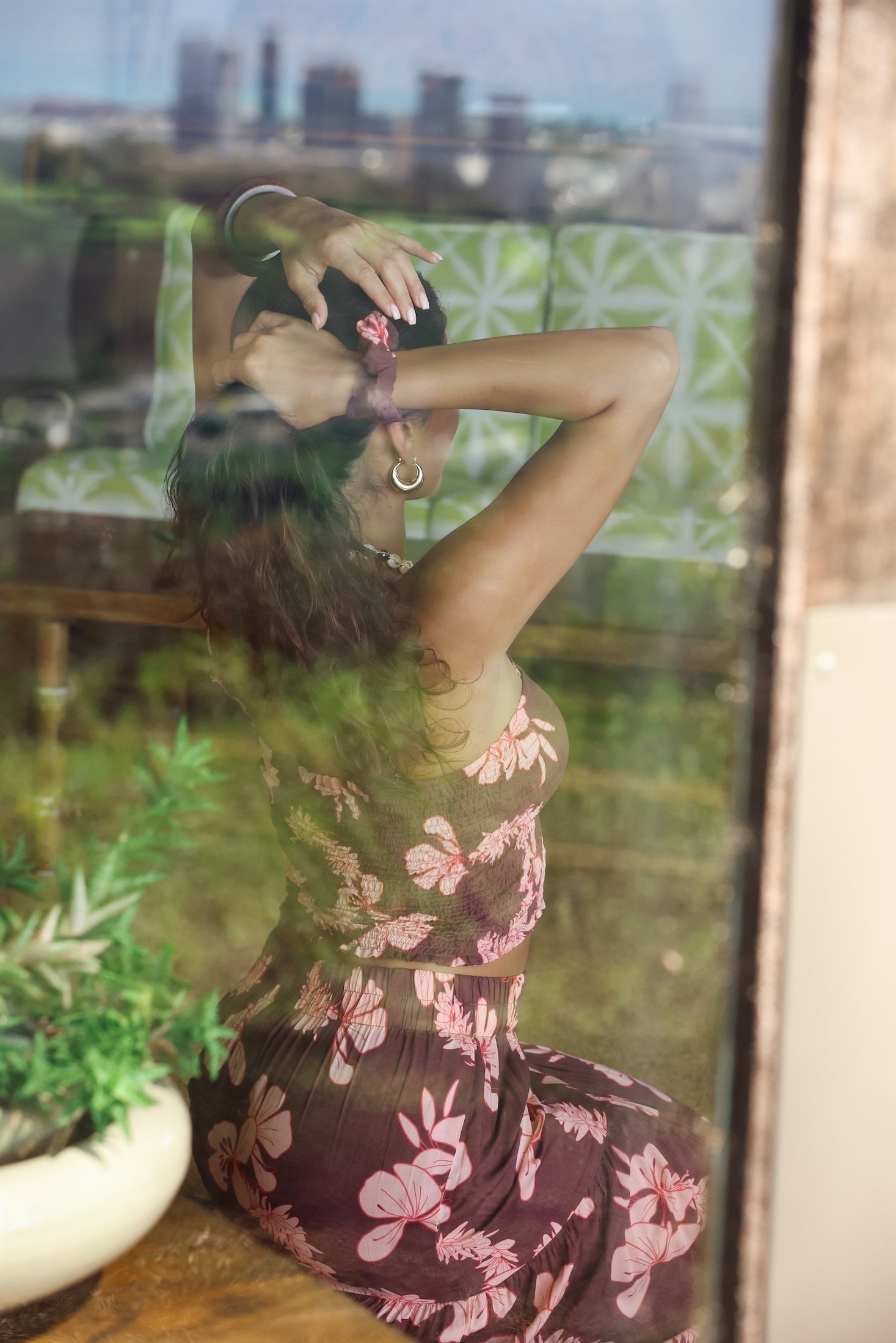 woman wearing mauve scrunchie with lei awapuhi print in hair