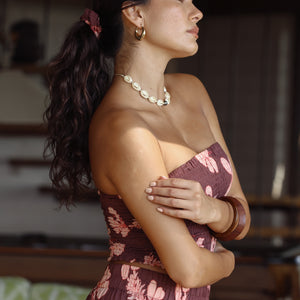 woman wearing mauve scrunchie with lei awapuhi print in hair