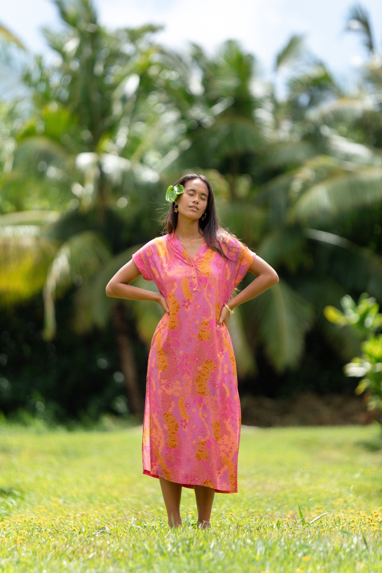 woman wearing a pink v neck maxi dress with lei print