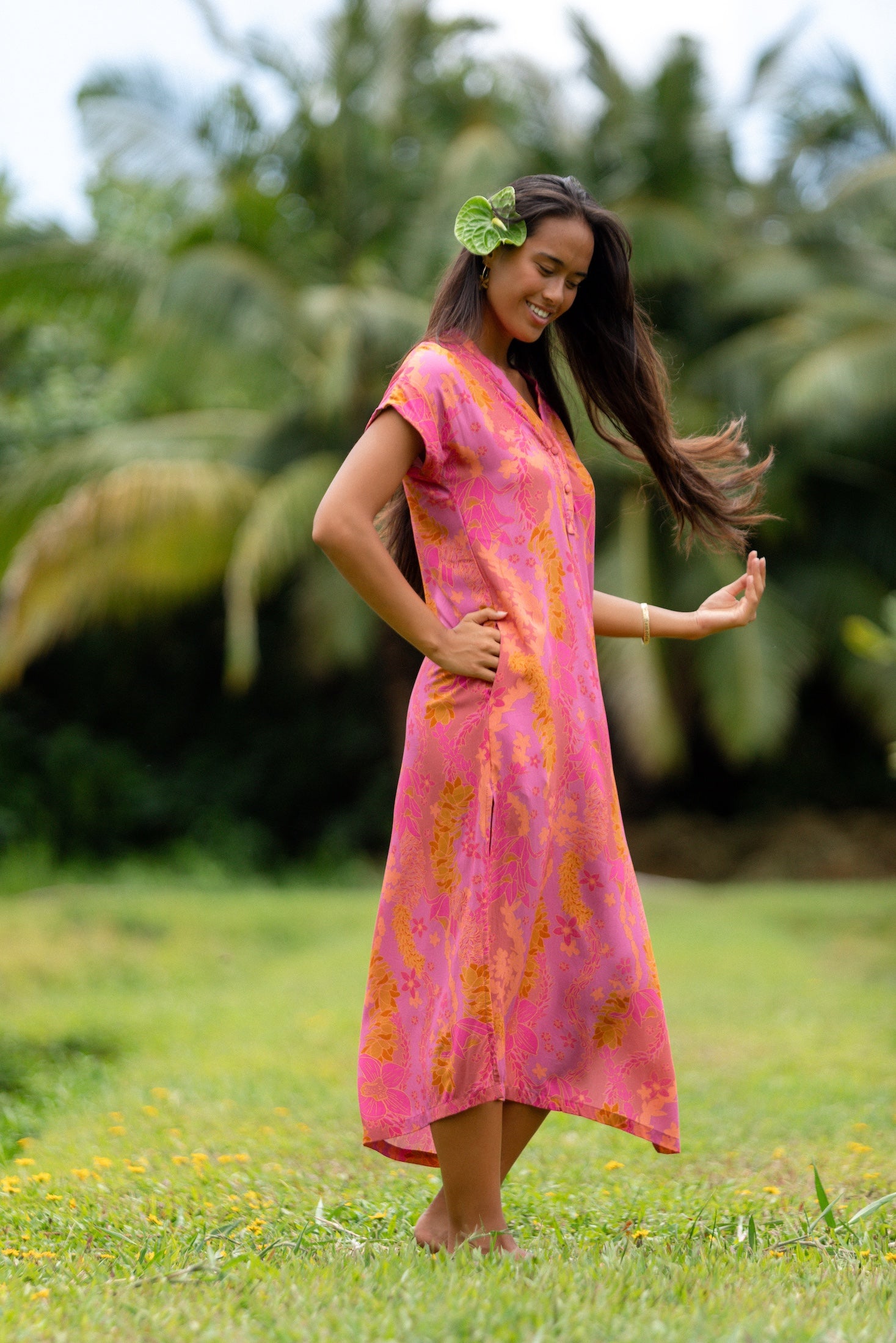 woman wearing a pink v neck maxi dress with lei print