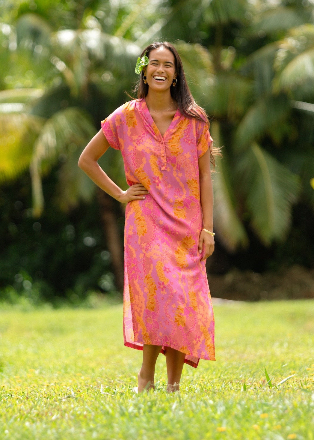 woman wearing a pink v neck maxi dress with lei print