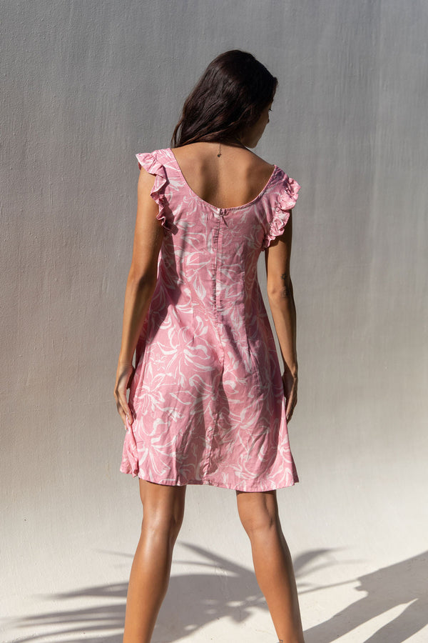 The Yireh Capri Dress in Petal. A romantic style featuring an A-line silhouette, a zipper back, and ruffles around the sleeves. This dress was ethically and sustainably made and features an exclusive one of a kind print. 