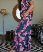 Woman with top and pants in navy with pink ginger and lei print.