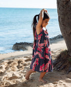 Girl in dress with dark navy ground and pink ginger and lei.