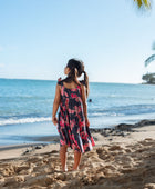 Girl in dress with dark navy ground and pink ginger and lei.