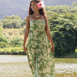 woman with brown hair wearing green tie back dress with native hawaiian plants