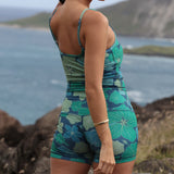 woman wearing matching activewear tank top and shorts in dark blue floral print