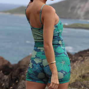woman wearing matching activewear tank top and shorts in dark blue floral print