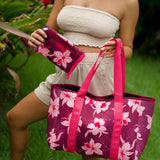 woman carrying wine colored neoprene tote bag with thick straps and detachable pouch with orchid print