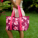 woman carrying wine colored neoprene tote bag with thick straps and detachable pouch with orchid print