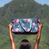 woman carrying a rich teal neoprene tote with blush colored protea print