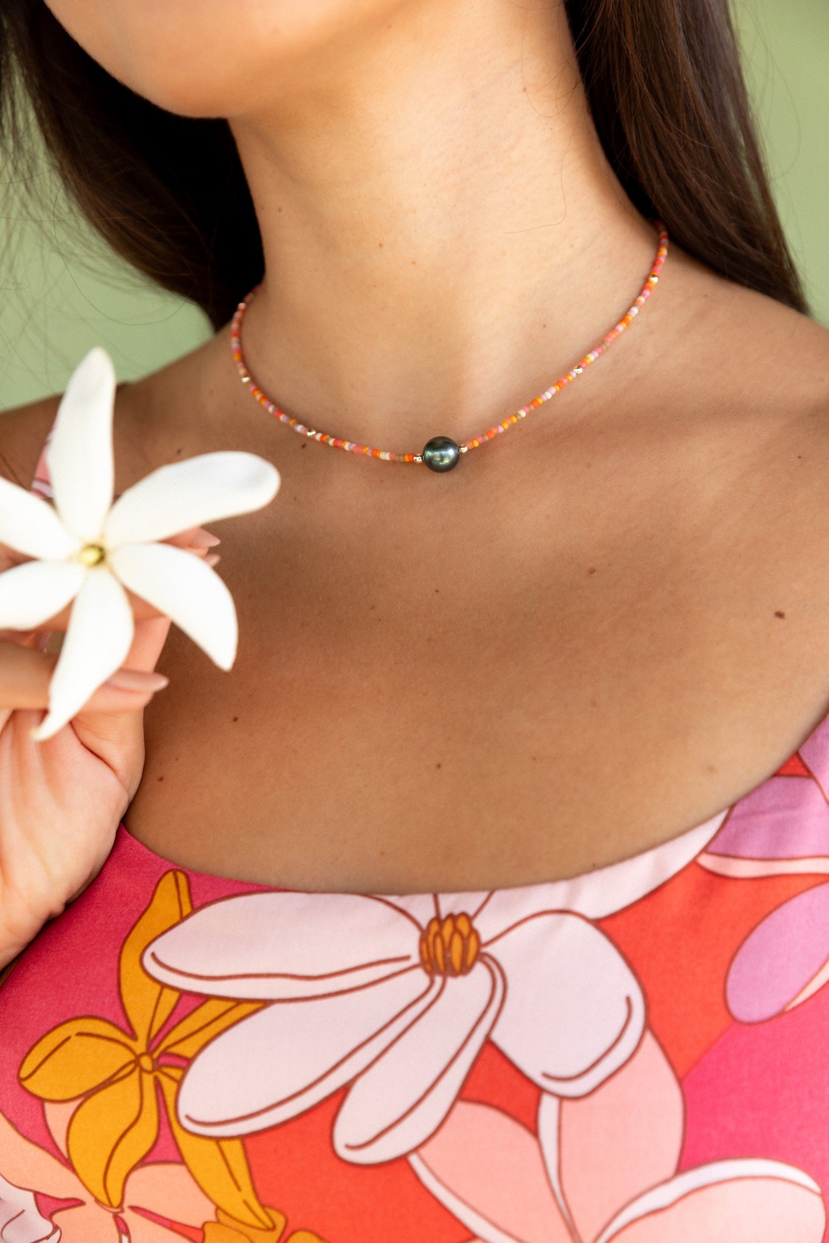 woman wearing a beaded necklace with pearl