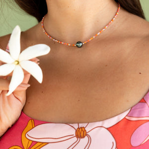woman wearing a beaded necklace with pearl