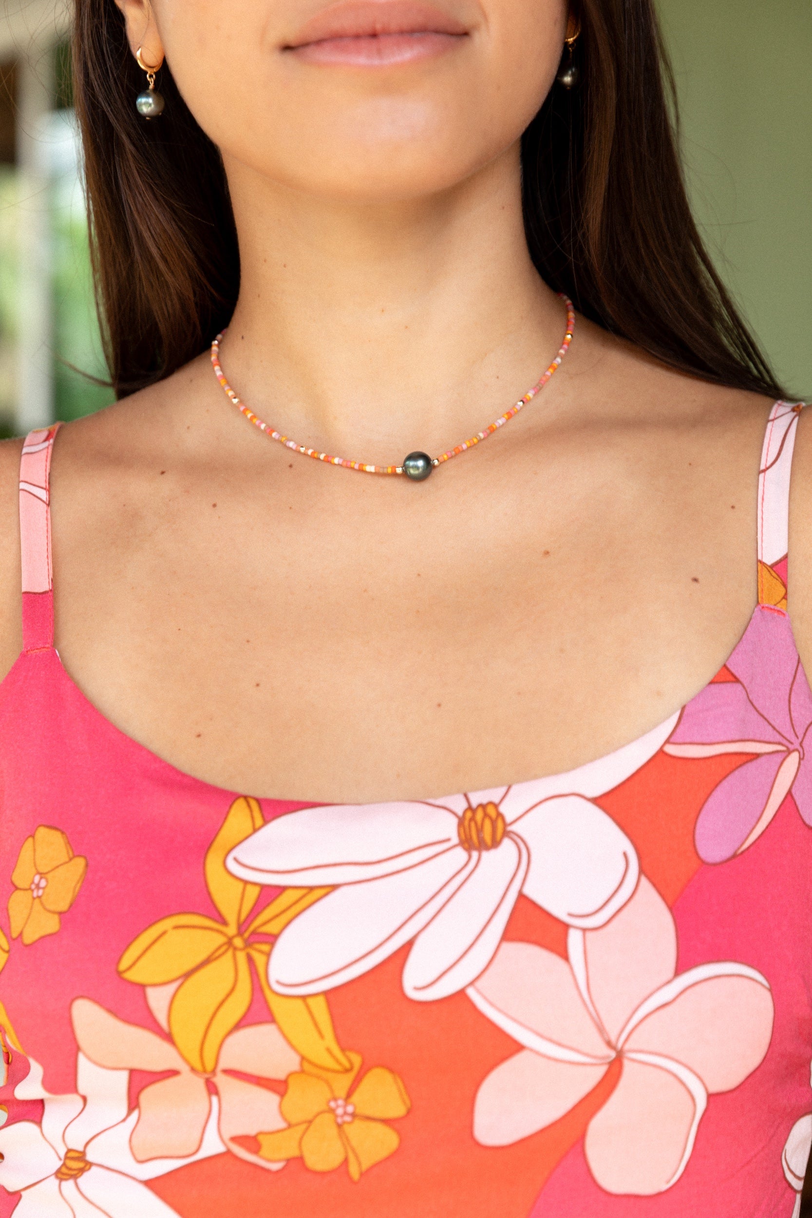 woman wearing a beaded necklace with pearl