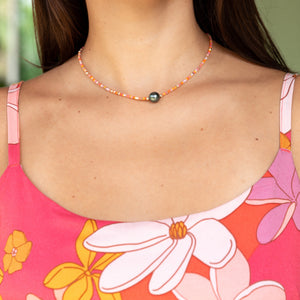 woman wearing a beaded necklace with pearl